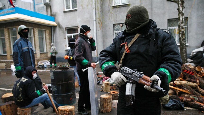Pro-Russian gunmen outside police headquarters in eastern Ukraine