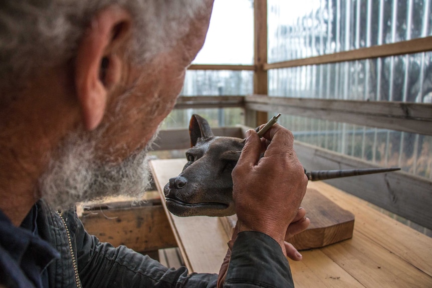 Artist David Hurst working on the wax Tasmanian tiger head.