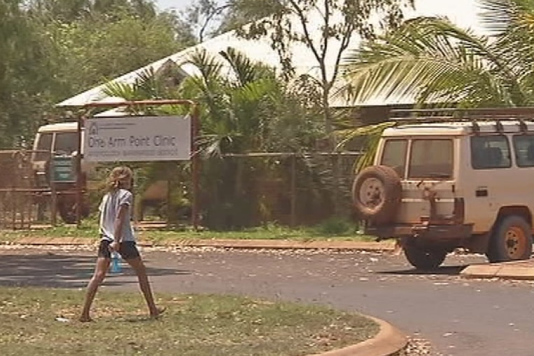 A young girl walks in front of One Arm Point clinic in Kimberley