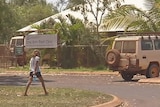 A young girl walks in front of One Arm Point clinic in Kimberley