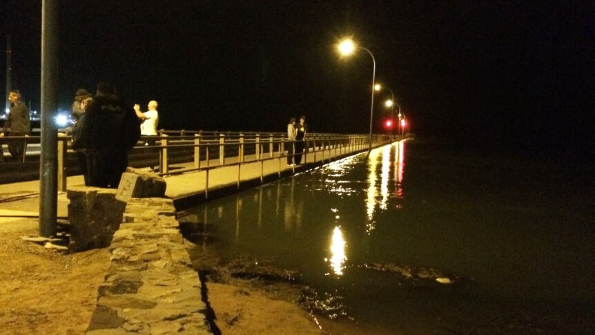 Locals checked out the high sea level from the Port Pirie jetty