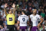 A referee holds up 10 fingers as he sends an NRL player to the sin-bin during a match.