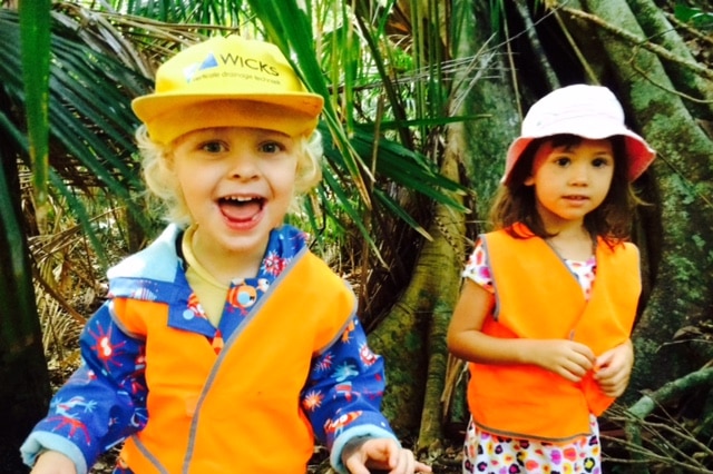 Two young girls enjoy a session at the Port Macquarie Nature School, smiling in the forest