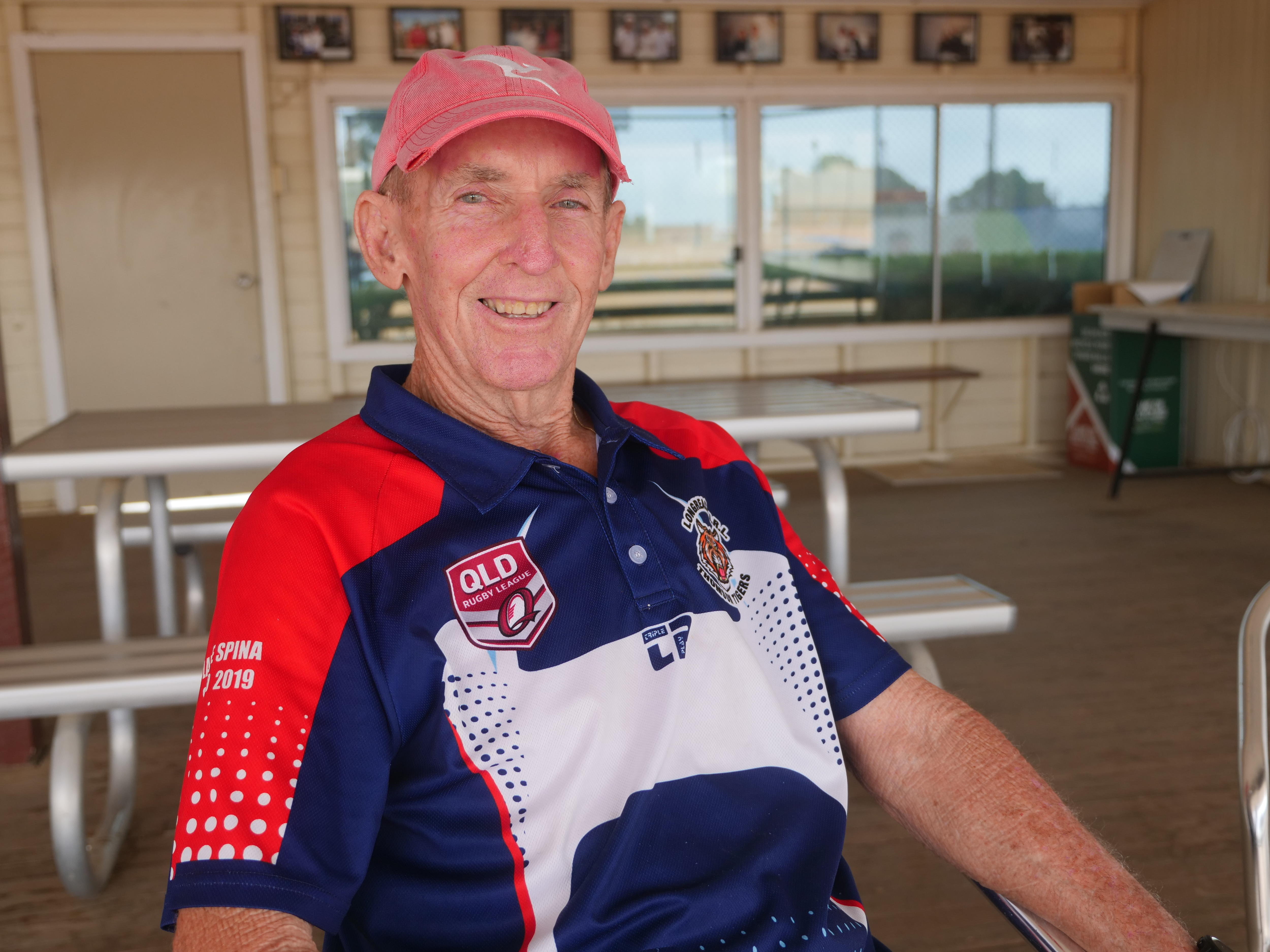 Older man in red cap smiling
