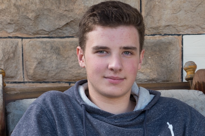 Jake Jurecky sits in a chair outside his Adelaide home.