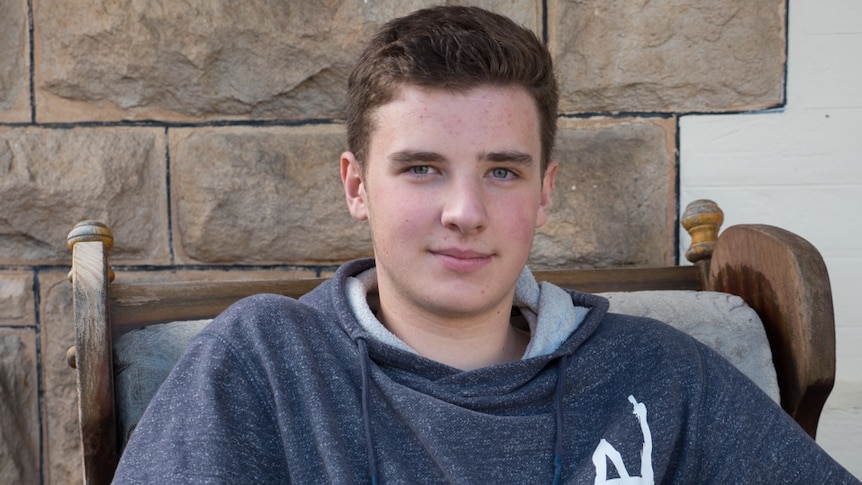 Jake Jurecky sits in a chair outside his Adelaide home.