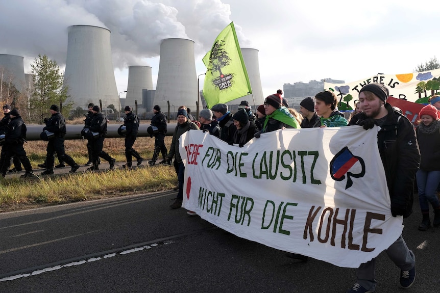 Protesters carry a banner reading 'Love for the Lausitz. Not for the coal'.