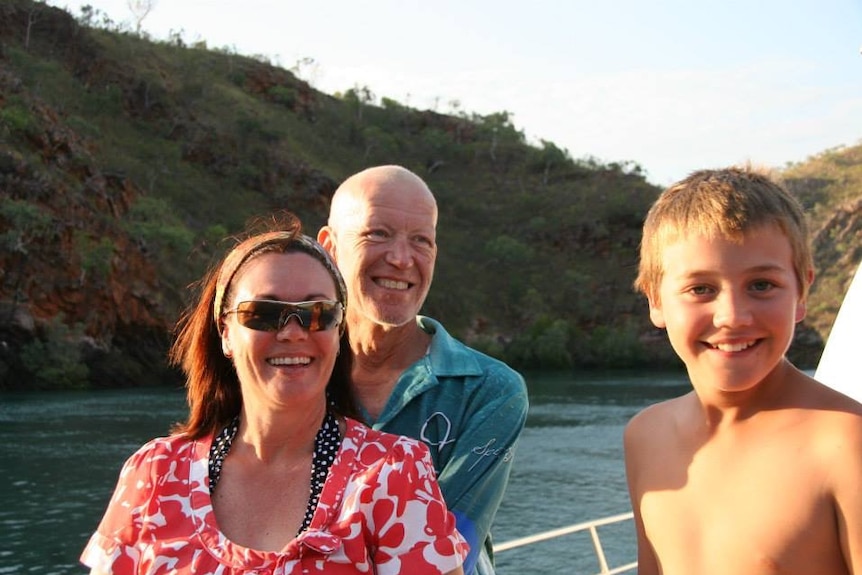 A man, woman and boy on a boat