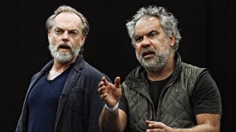 Hugo Weaving and Wayne Blair against black background, performing their dialogue.