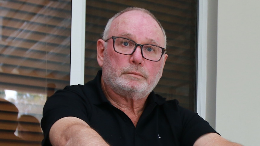 An up-close photo of a man with a red face