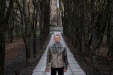 A portrait of Valerii Semenov standing among bare trees.