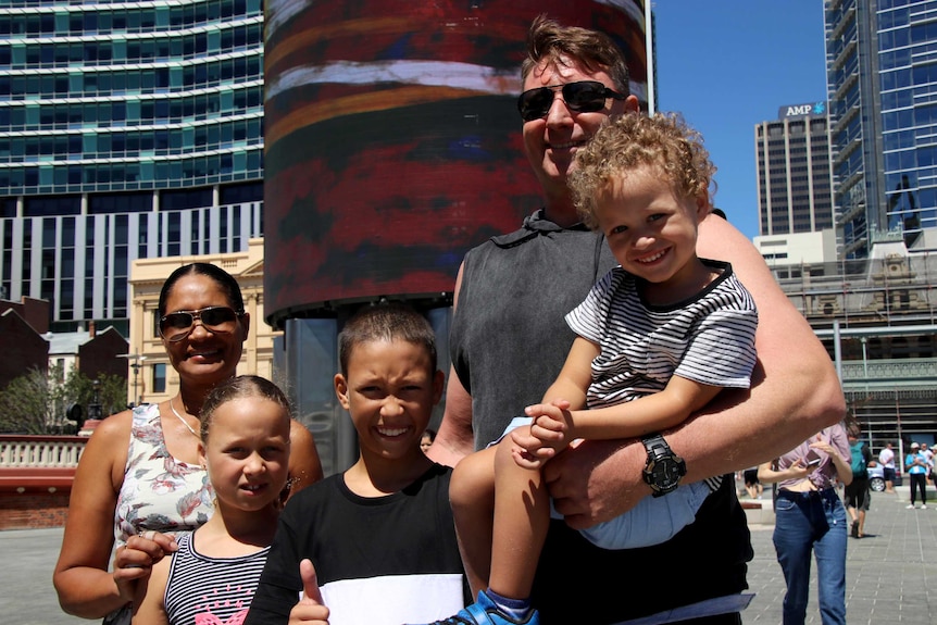 A man and a woman and their three children.