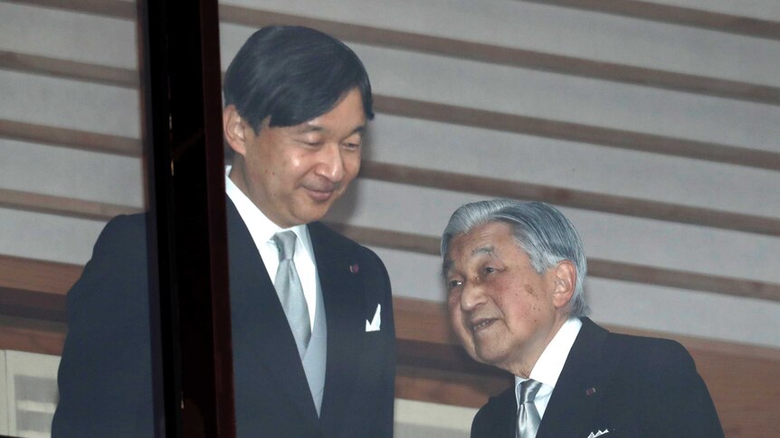 Emperor Akihito and Crown Prince Naruhito stand side by side.