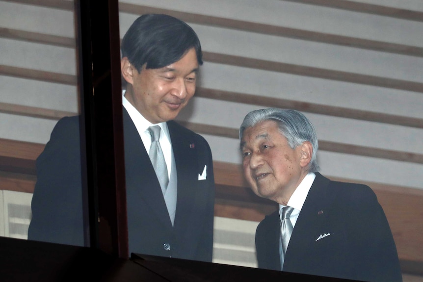 Emperor Akihito and Crown Prince Naruhito stand side by side.