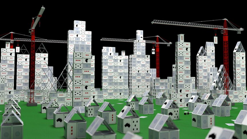Image of a city full of both houses and towers being constructed out of cards by tall cranes.