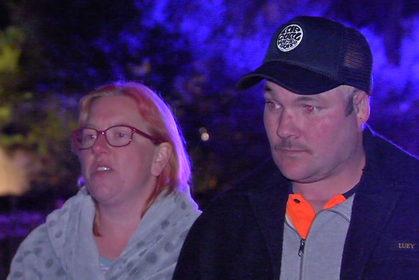 Sarah Burgess and Shane Raison stand outside the house.