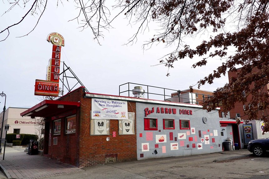 Exterior of the Red Arrow Diner, with leafless tree branches overhanging in the foreground.