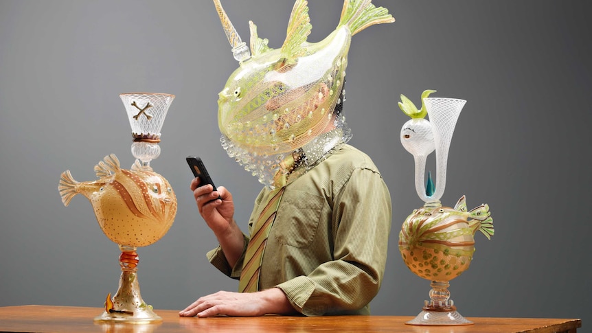 The two puffer fish figures topped by goblets with a man in a Tom Moore helmet for scale