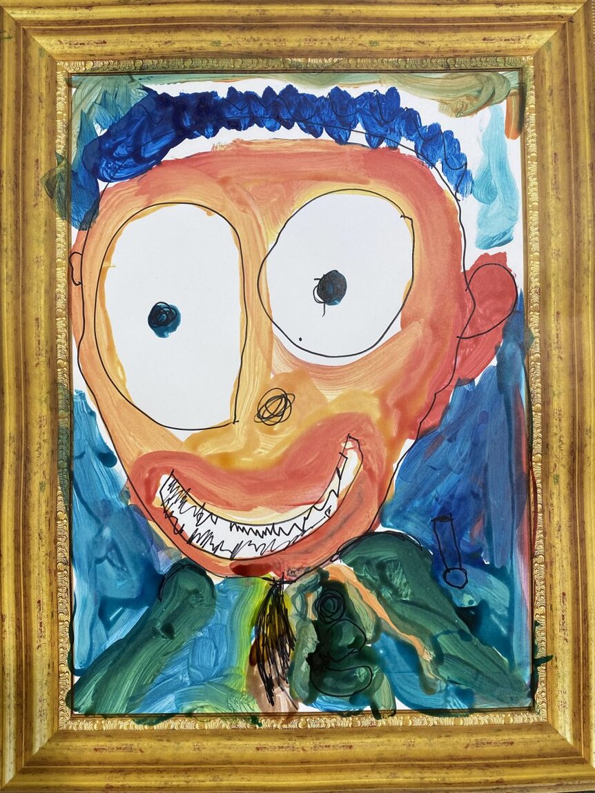 A bright portrait by a kid of a face with orange skin and bulging eyes