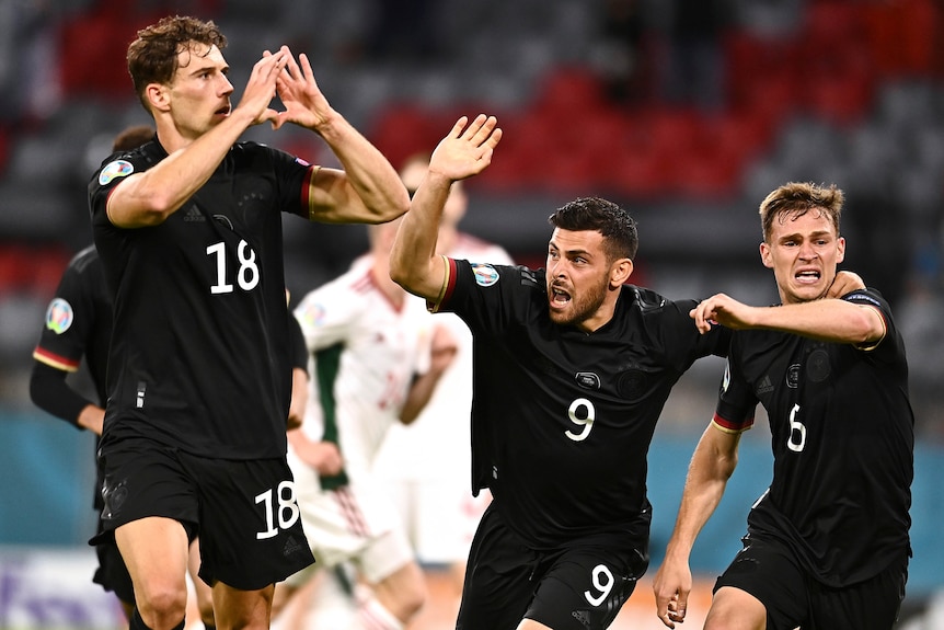 A German footballer makes a heart shape with his hands in celebration after scoring a goal at Euro 2020.