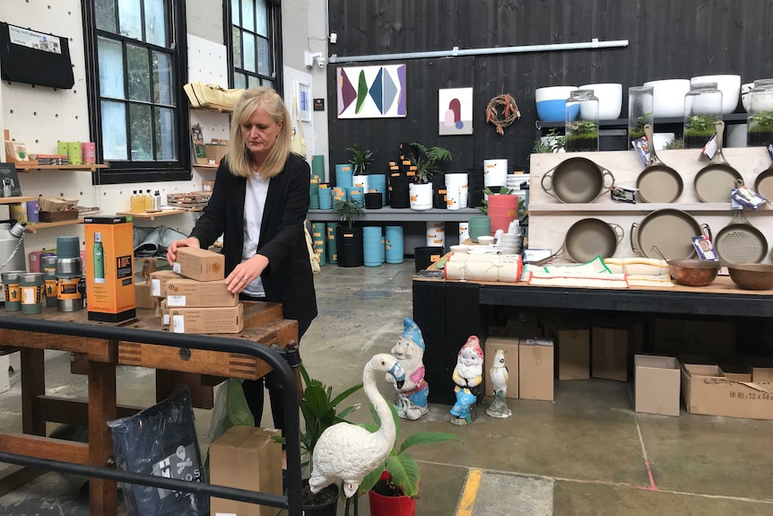 Sasha Titchkosky, Koskela co-founder, examines products in her showroom.