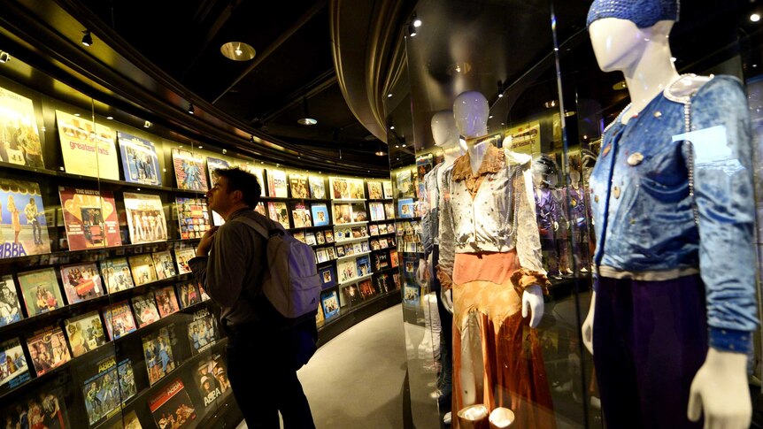 A fan walks through the Gold Room at the ABBA museum.