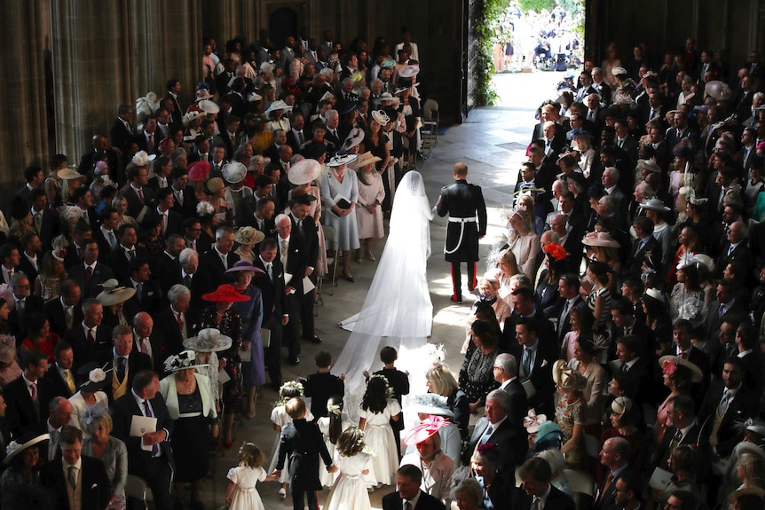 Prince Harry and Meghan Markle walk down the aisle after their wedding ceremony at St. George's Chapel in Windsor Castle.