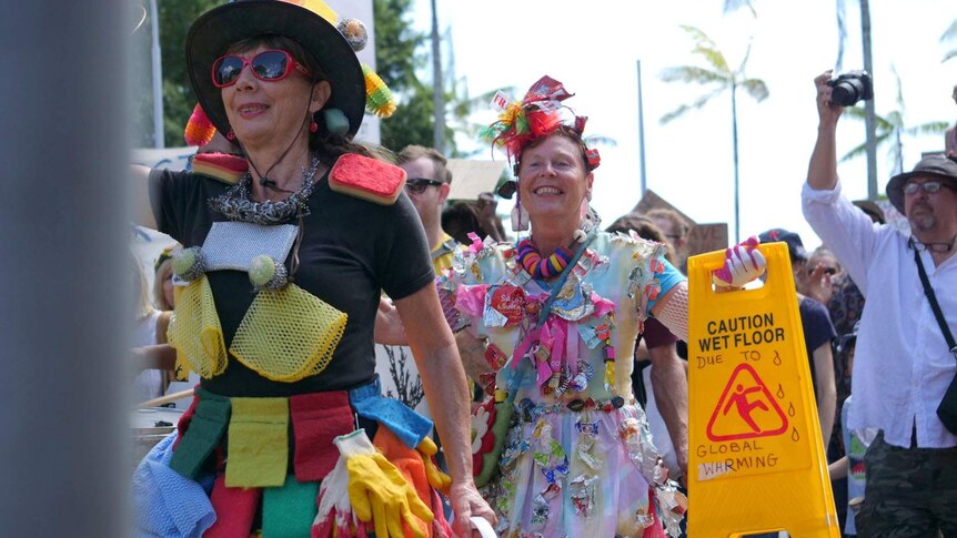 Colourful climate activists marching in Cairns