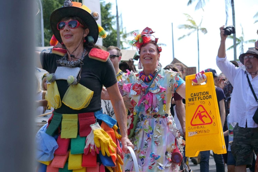 Colourful climate activists marching in Cairns