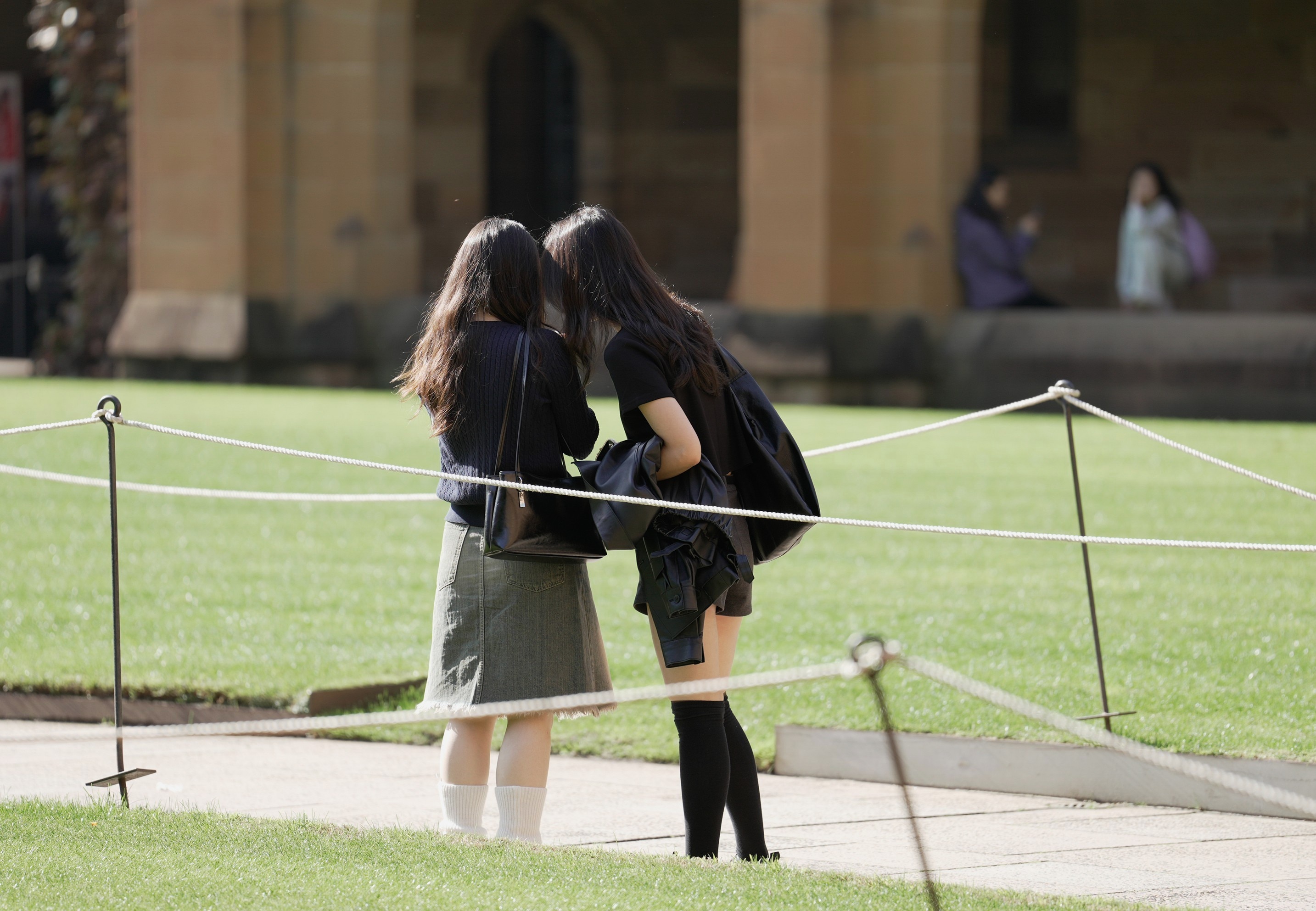 Two unidentified girls in the middle of a university courtyard