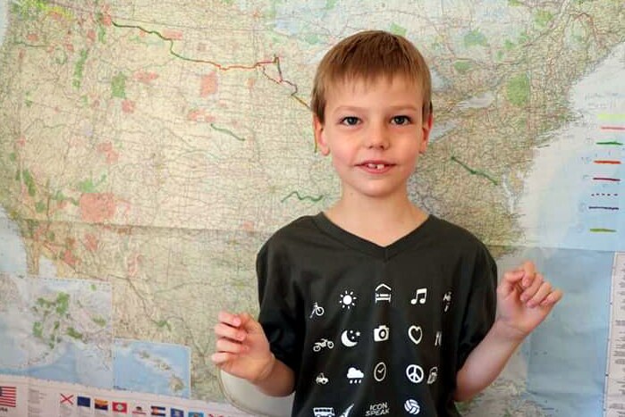 A child in front of a map of the United States of America.
