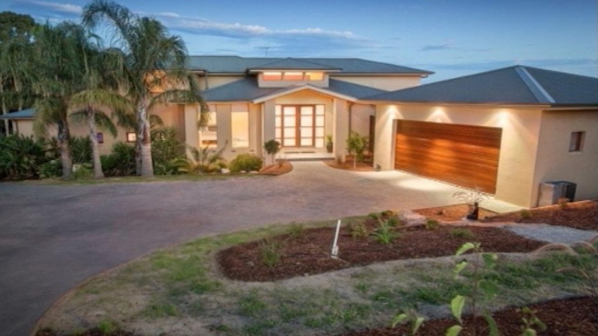 A large home owned by the Hoth Mai family surrounded by palm trees in Narre Warren, Victoria.