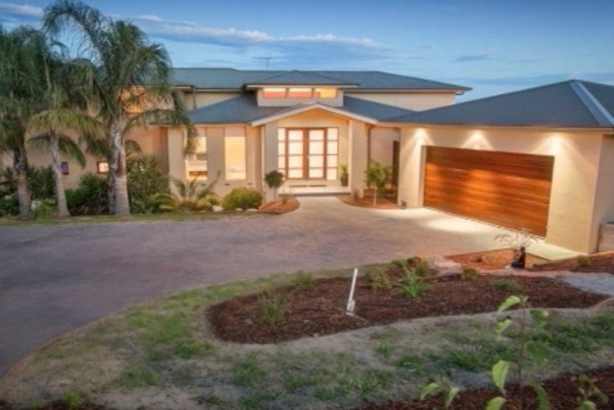 A large home owned by the Hoth Mai family surrounded by palm trees in Narre Warren, Victoria.