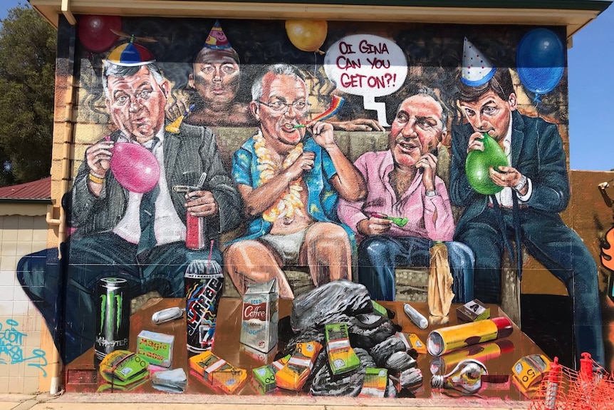 A mural of four men with balloons and party poppers