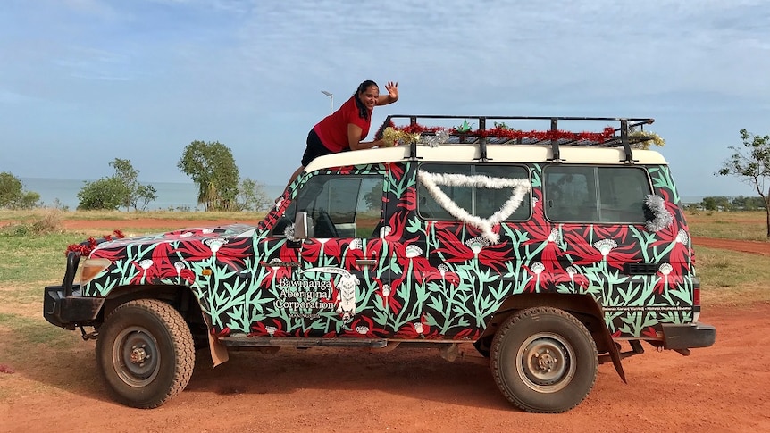 Ladies in a colourful four-wheel-drive delivering presents around the bush.