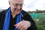 A tight shot of Ian Gladstone with a snail on his hand.