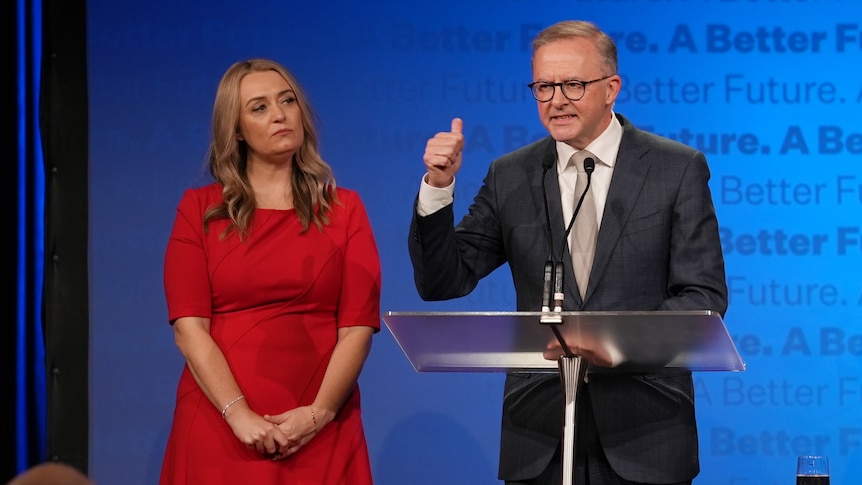 Anthony Albanese gives a thumbs up as Jodie Haydon stands alongside him at an election night event