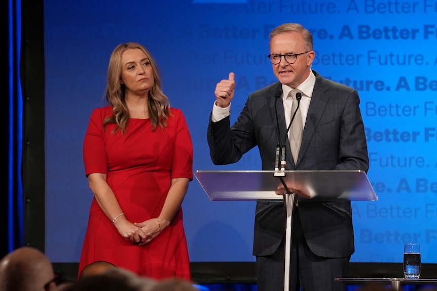 Anthony Albanese gives a thumbs up as Jodie Haydon stands alongside him at an election night event