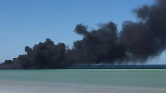 Black smoke coming from a jetty above the ocean in Whyalla