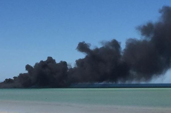 Black smoke coming from a jetty above the ocean in Whyalla