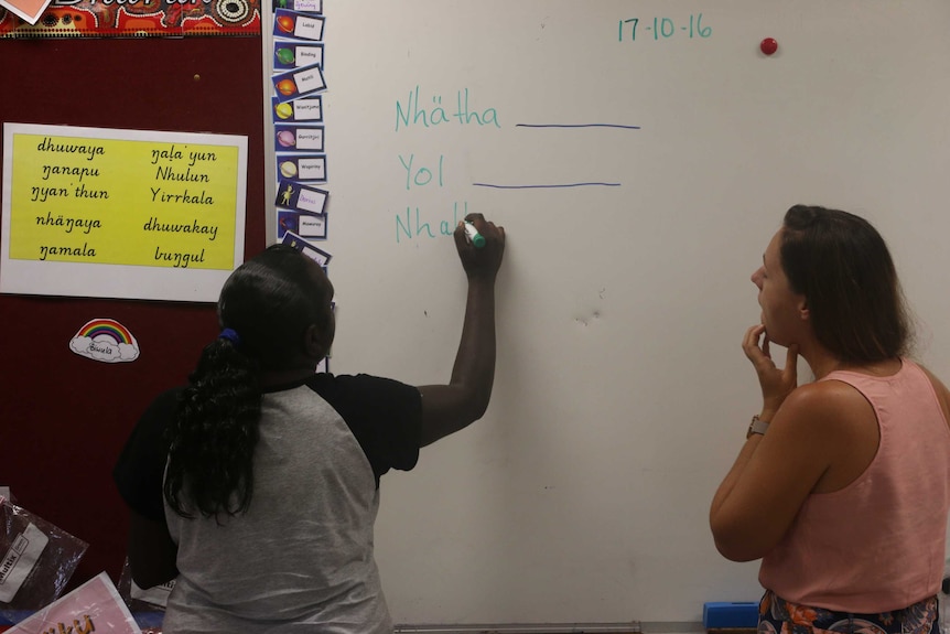 Teachers at Yirrkala School writing words in Yolngu language on the board