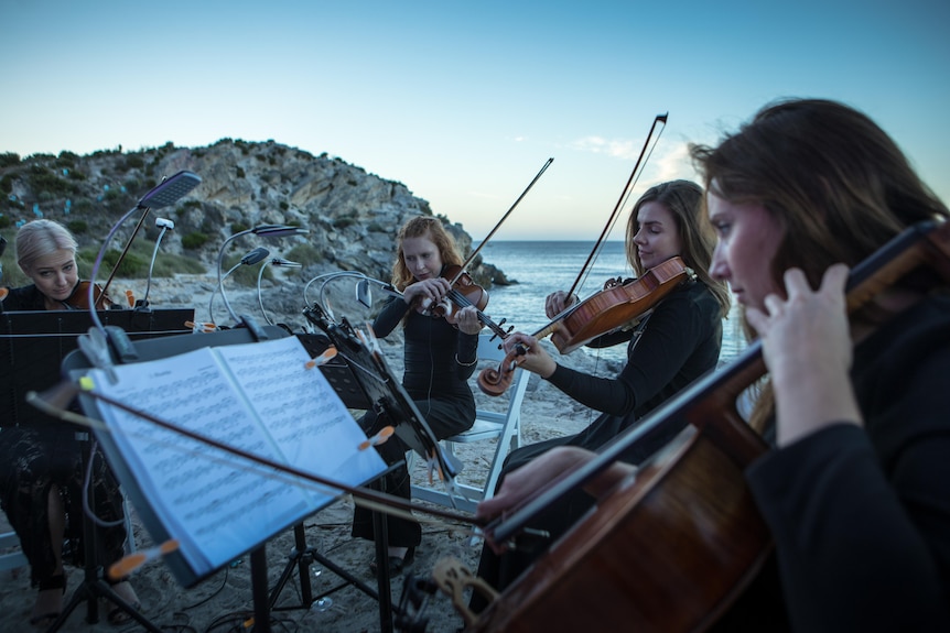 Members of Perth Symphony Orchestra performing on a beach on Rottnest Island.