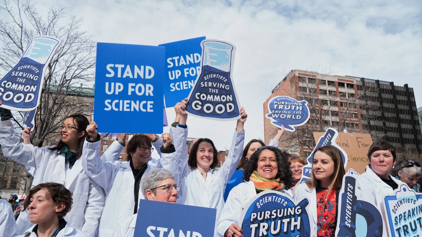 Group of scientists hold signs at the Stand up for Science rally in Boston's Copley Square