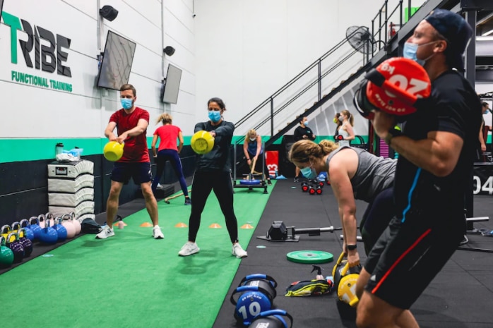 People using weights work out on the gym floor