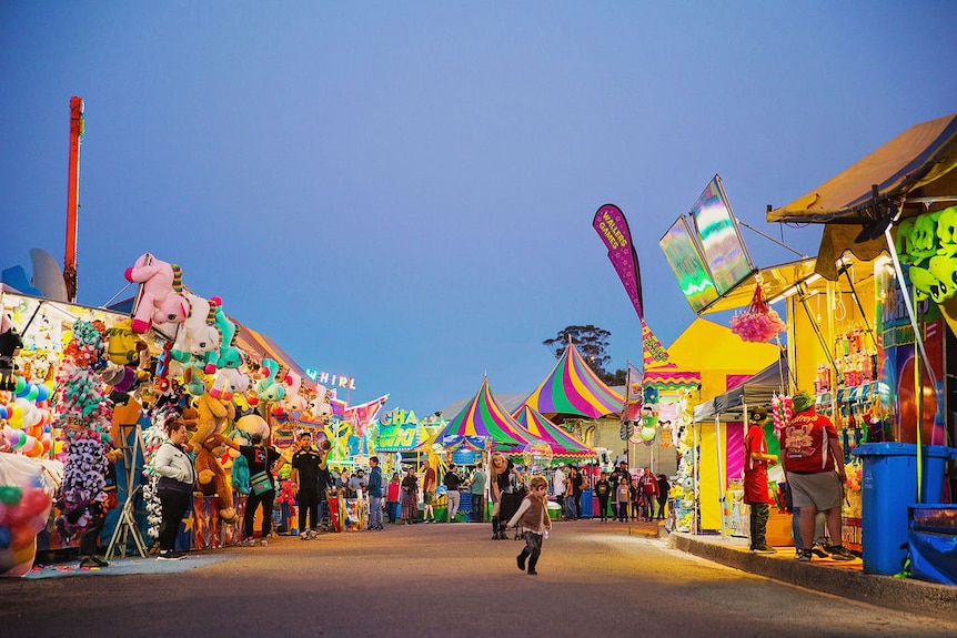 Various multicolored stalls surrounded by lighting