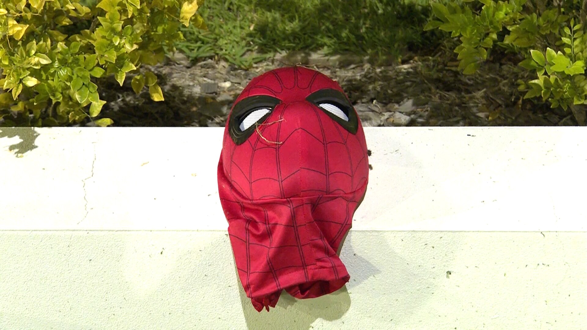 A spider man mask on a ledge.