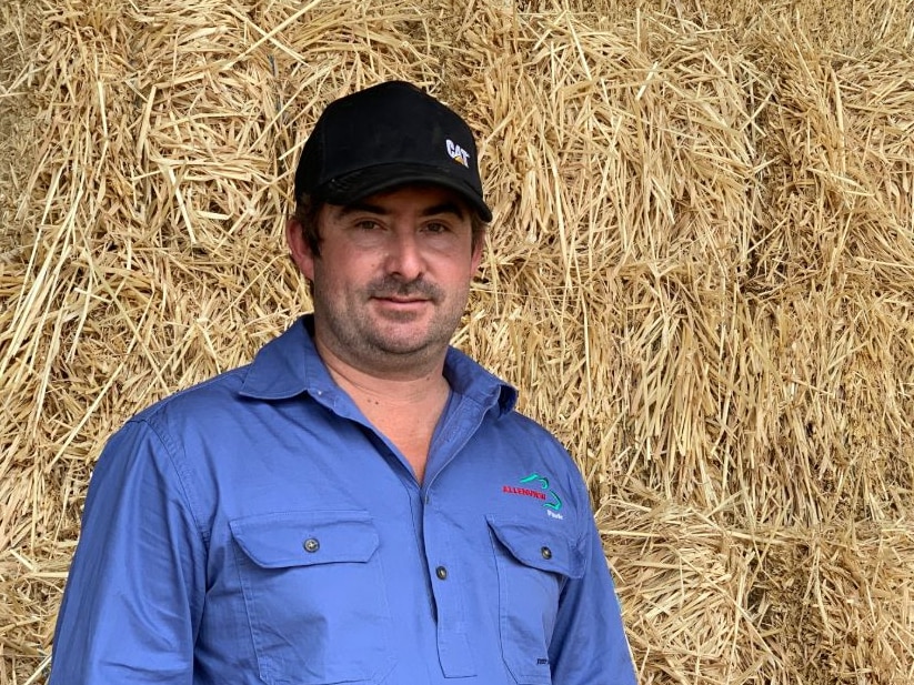 James Radke stands in front of hay bales in his shed at Beenleigh