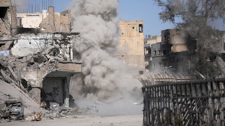 Smoke rises after a landmine explodes in Raqqa.