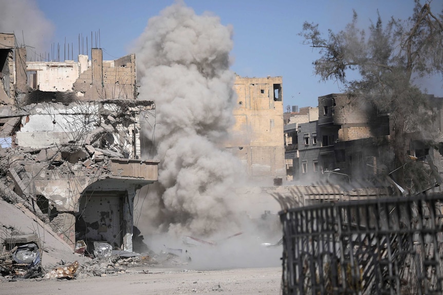 Smoke rises after a landmine explodes in Raqqa.
