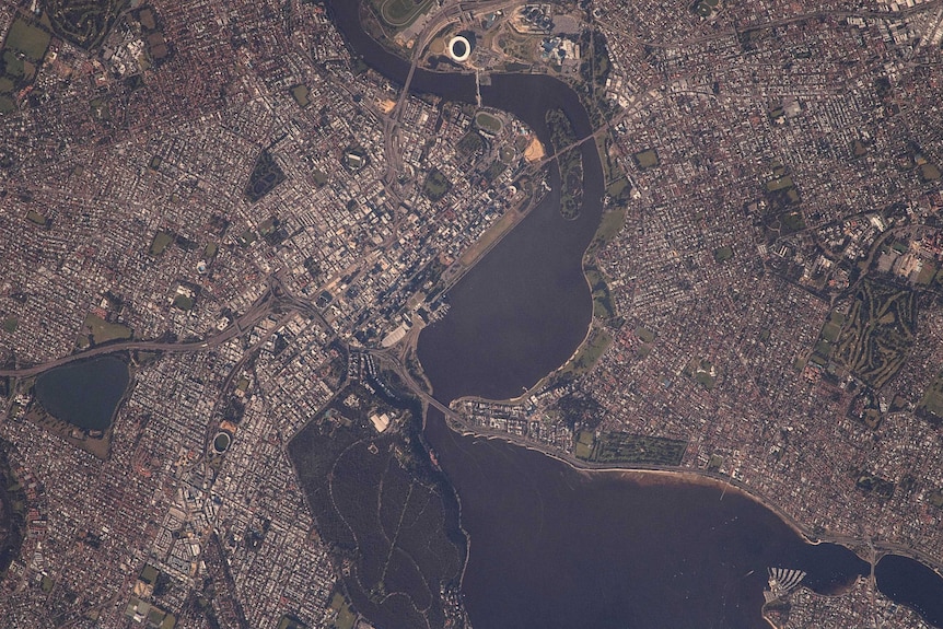 An aerial shot of a sprawling metropolitan area taken from space
